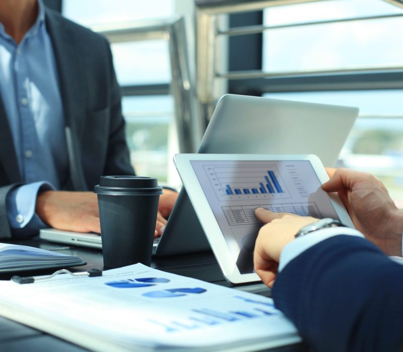Business person analyzing financial statistics displayed on the tablet screen