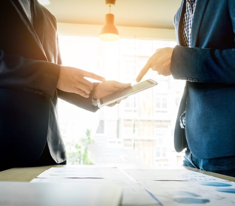 Team work process. young business managers crew working with new startup project. labtop on wood table, typing keyboard, texting message, analyze graph plans.
